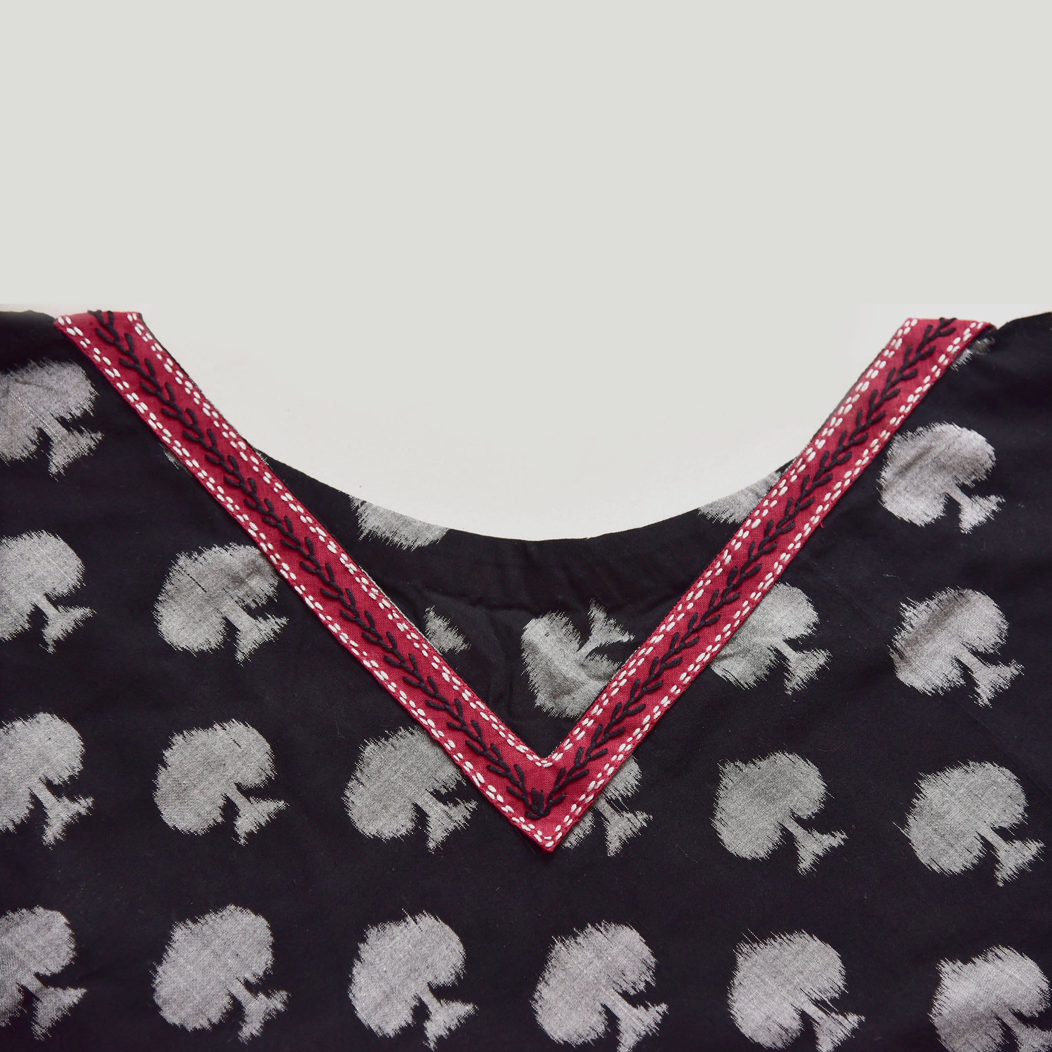 Neck detailing- Handwoven Sambalpuri cotton ikat Black spade ikat triangle poncho with red edging amd yarn dyed tassels