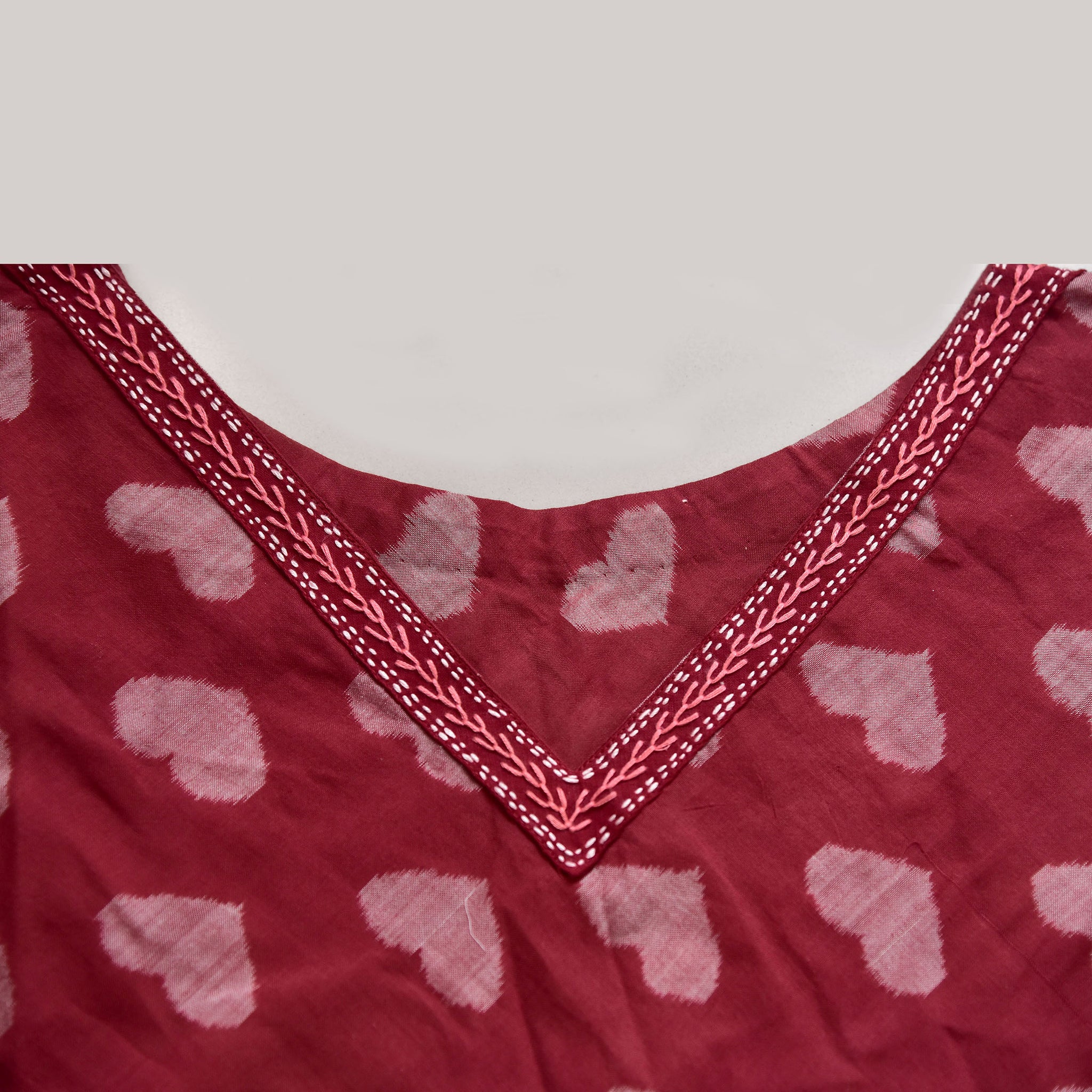 Sambalpuri triangle maroon ikat poncho with allover taash hearts and hand embroidery detailing on neck