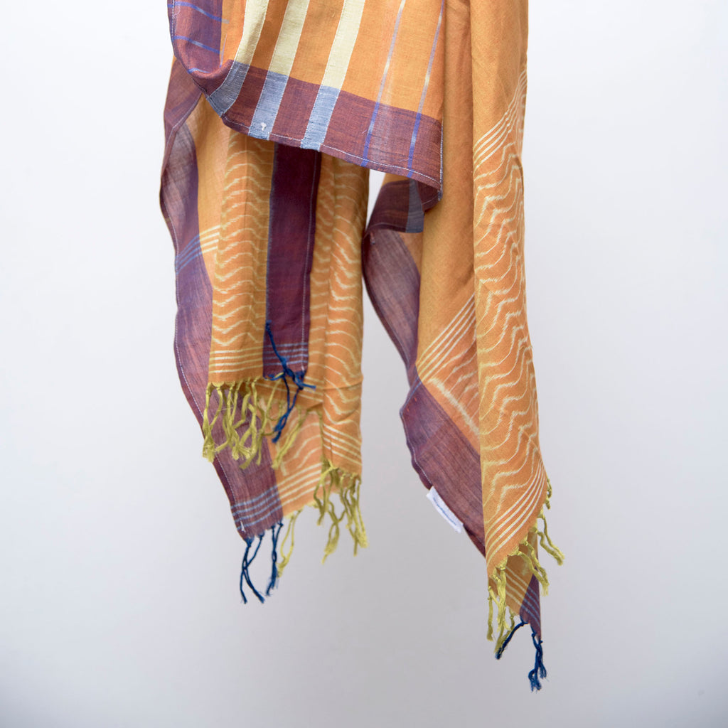 Sambalpuri orange cotton ikat stole with wave motifs on both ends.