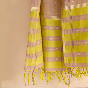 Shimmery green cotton ikat scarf with allover ikat dots and tassles at ends.