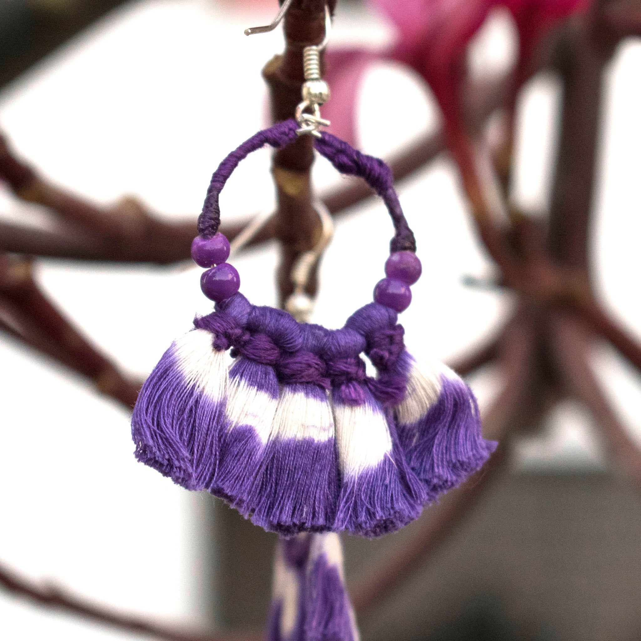 Earrings embellished with purple ikat tassels and beads