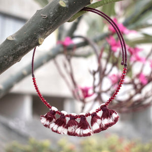 Wire choker embellished with maroon ikat tassels and beads