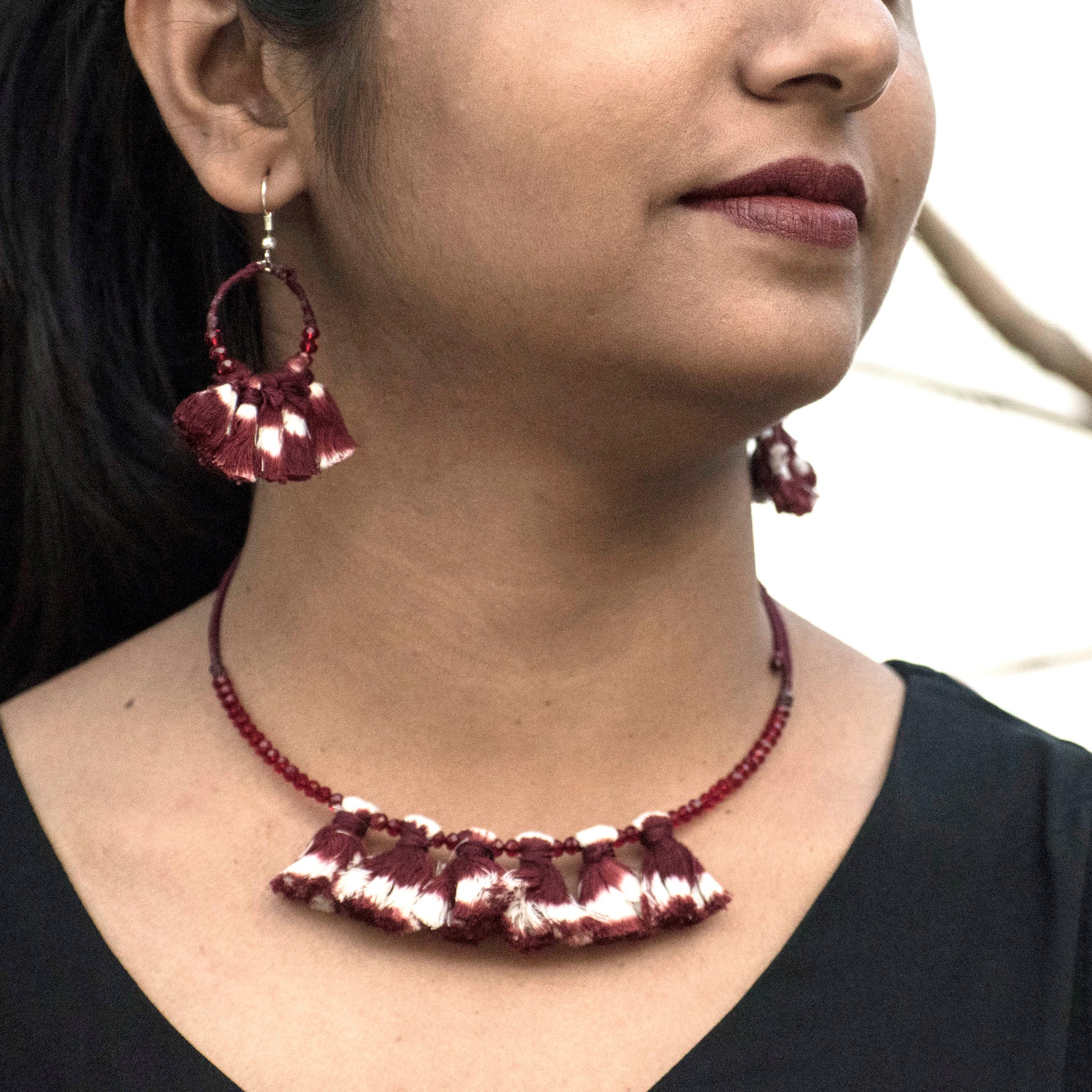 Wire choker and earrings embellished with maroon ikat tassels and beads