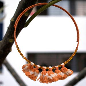 Handmade wire choker embellished with orange ikat tassels and beads