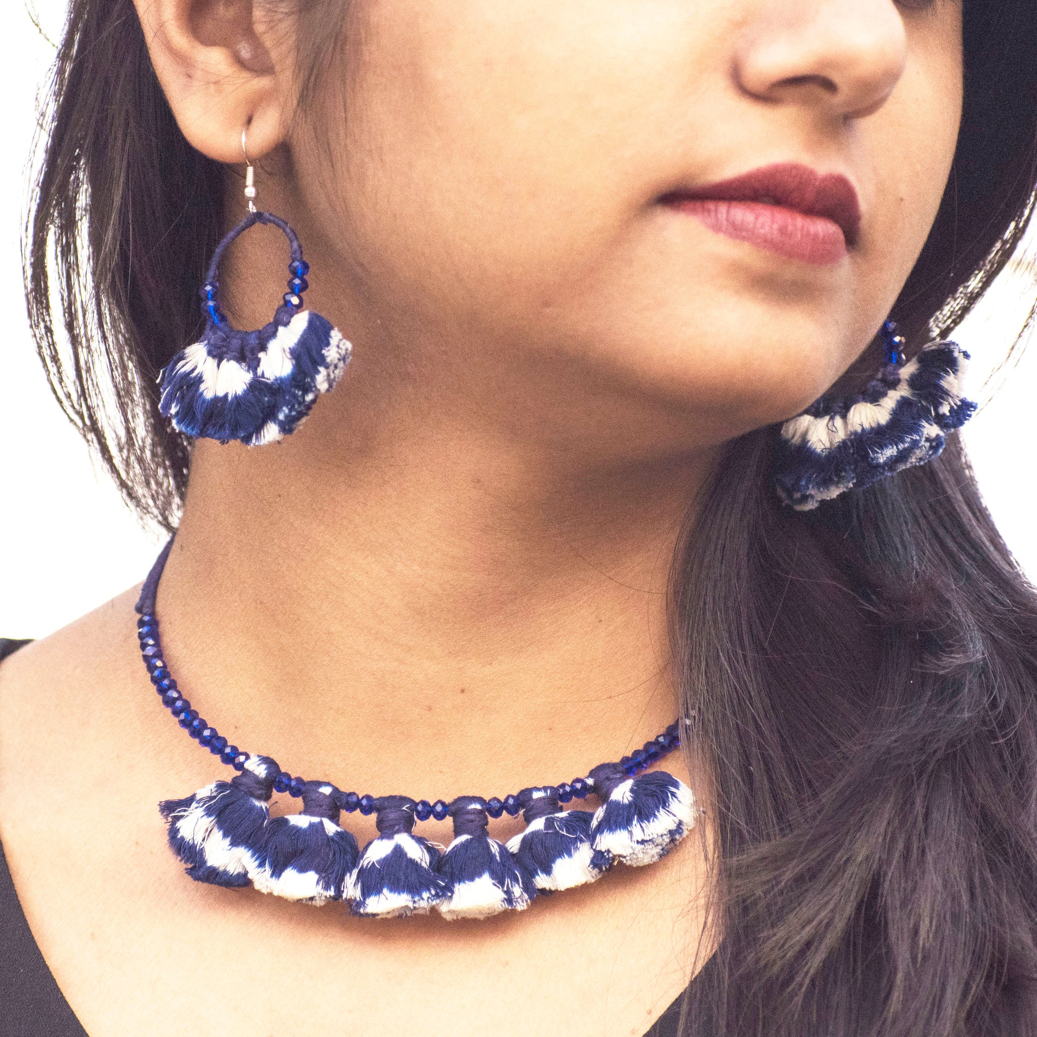 Wire choker and earring embellished with navy blue ikat tassels