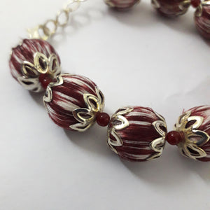 Close up- Handcrafted maroon ikat beaded bracelet